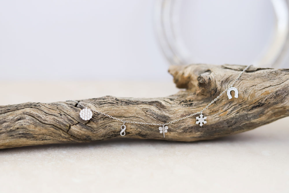 A sterling silver bracelet with lucky charms featuring CZ diamonds