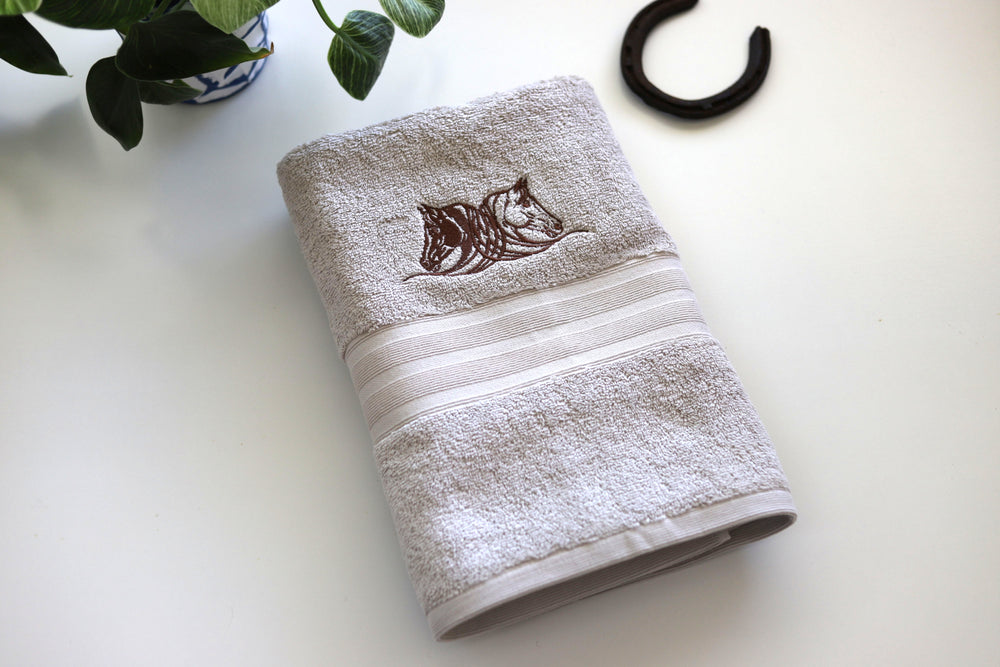 Cotton bath towel with embroidered horse heads