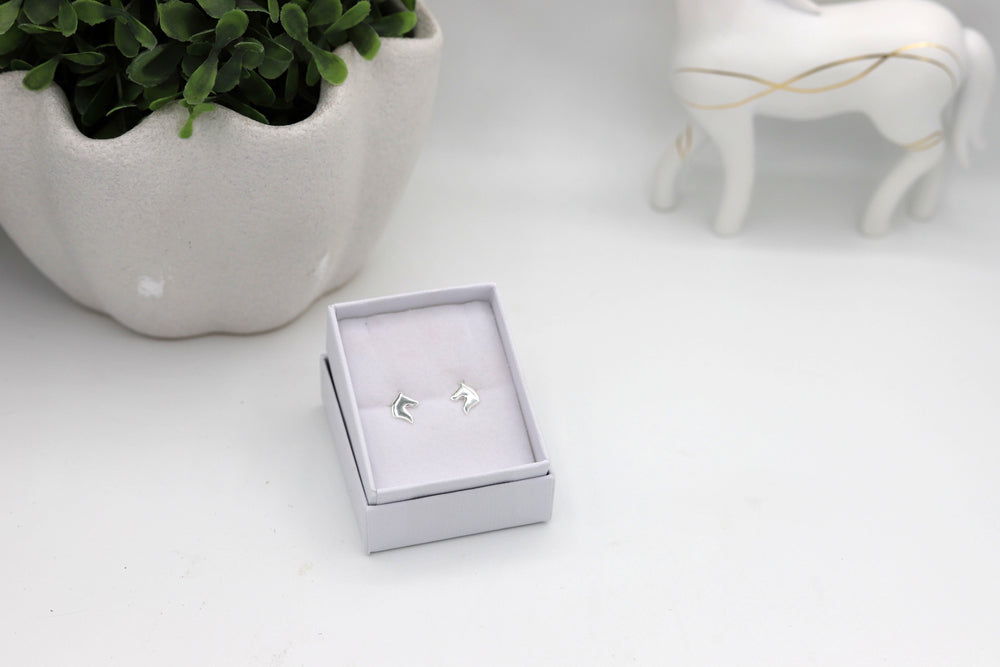 Sterling silver horsehead earstuds displayed in a jewellery box
