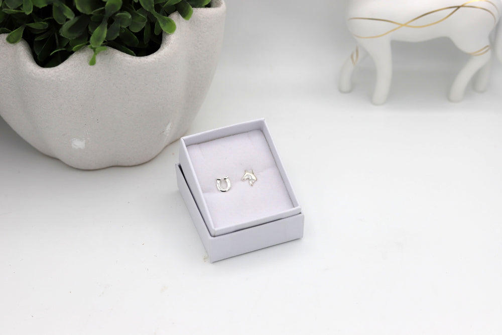 Sterling silver horse themed earstuds, one horsehead and one horseshoe diplayed in a jewellery box