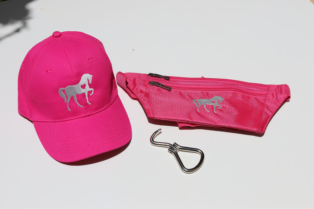 A set consisting of a hot pink baseball cap with a horse silhouette design, a matching pink waist pouch with pockets, and a foldable metal hoof pick.