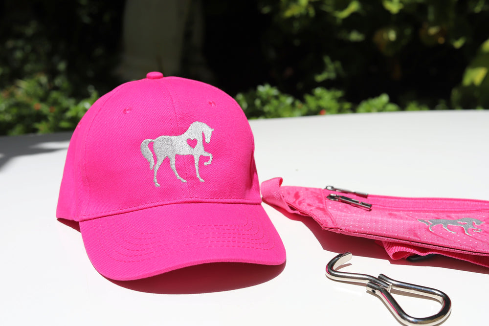 A set consisting of a pink baseball cap which is embroidered with a beautiful horse featuring a heart, a pink pouch with the same embroidered horse and a metal foldable hoof pick 