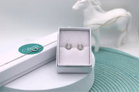 A Sterling silver horseshoe ear studs and sterling silver horse shoe bracelet set, ear studs are displayed in their jewellery box, the bracelet is lying on it's jewellery box
