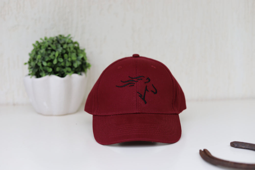 A burgundy baseball cap with a stylized black horse head embroidery on the front