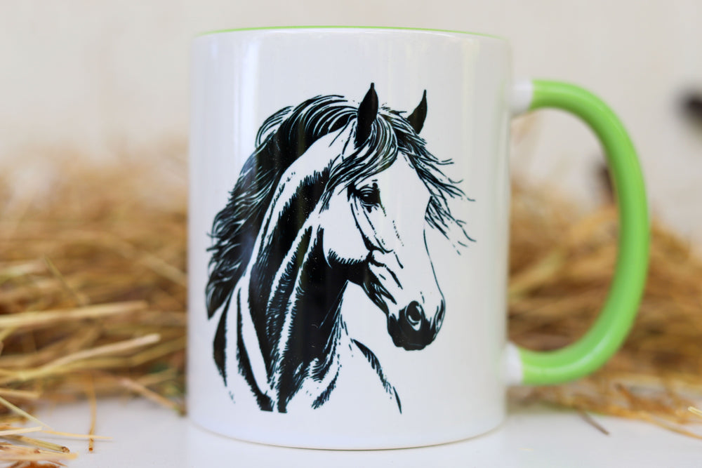 Close up of horse head art on white ceramic mug with green trim - equestrian gift