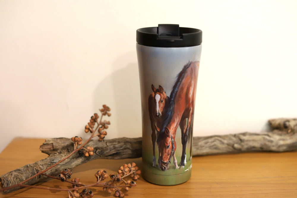 A stainless steel travel mug with a horse theme, featuring images of mares and foals on both the front and back.