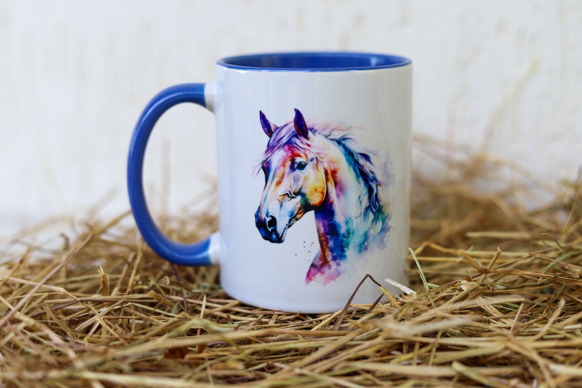 A white ceramic mug with blue trim with a watercolour horse head art on both sides - horse gift Australia