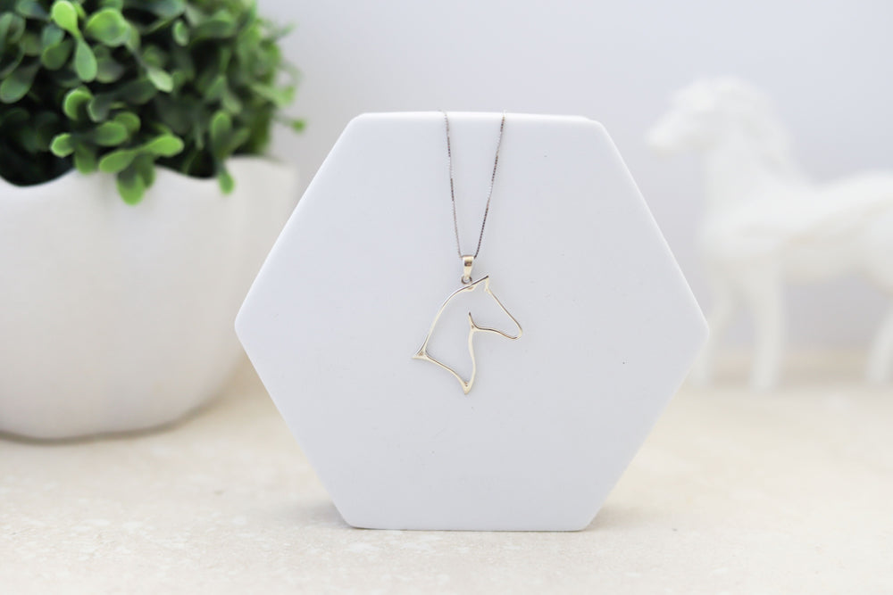 A sterling silver horse head outline pendant with a sterling silver rhodium plated chain