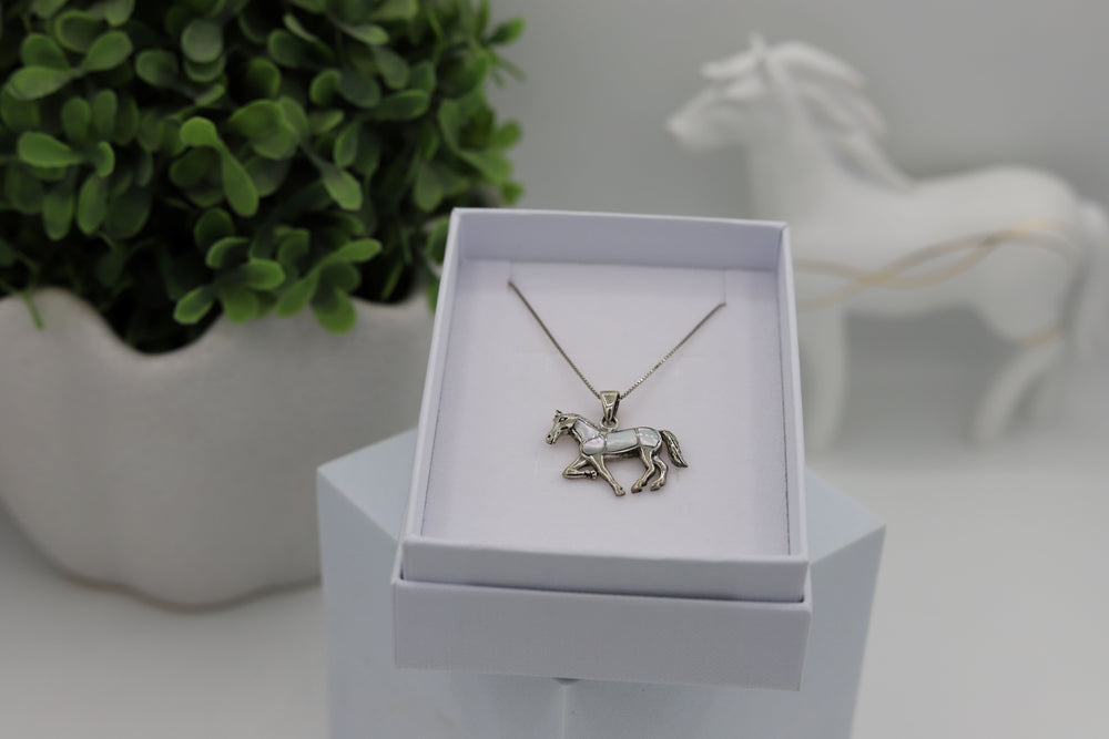 A Sterling silver horse pendant with Mother of pearl inlay and a sterling silver rhodium plated chain