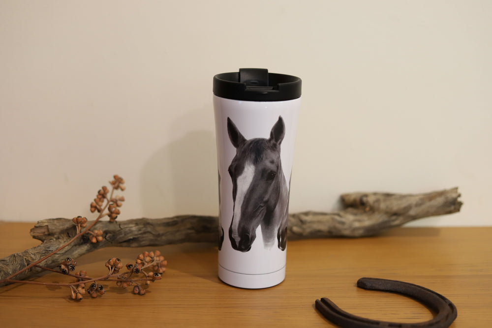 A stainless steel travel mug from the Trio collection featuring one of the 3 chestnut horse designs