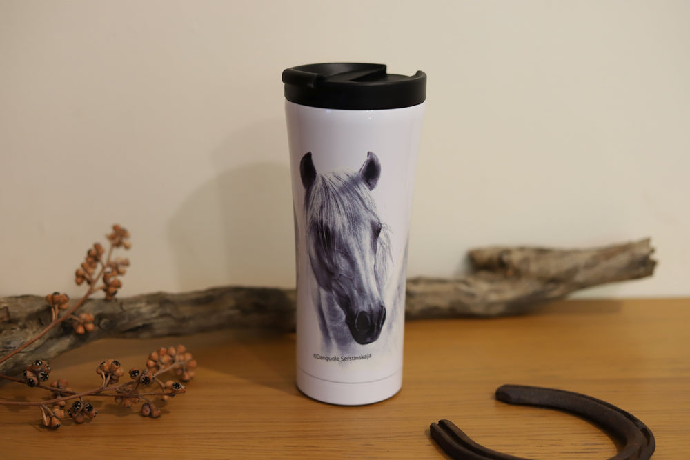 A travel mug with a grey horse design, featuring a double walled construction, placed on a wooden surface