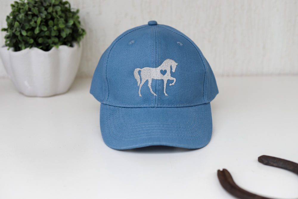 A light blue baseball cap with an embroidered horse design on it - horse lover gift