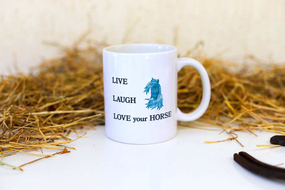 Equestrian horse mug with the words 'Live Laugh Love your Horse' and a mandala horse design on front and back of the white mug - hay in the background for display